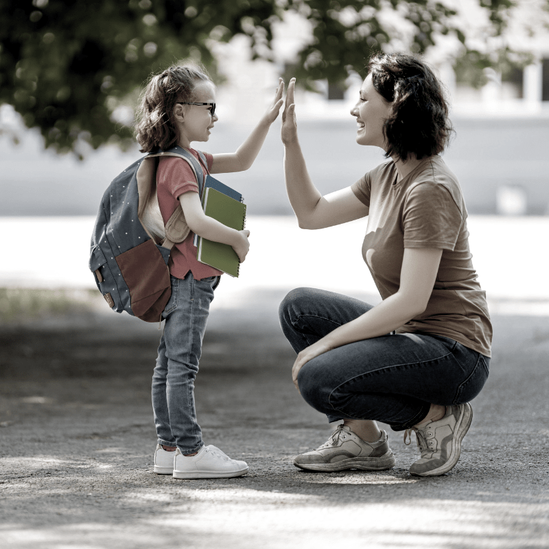 a mother taking her daughter to school